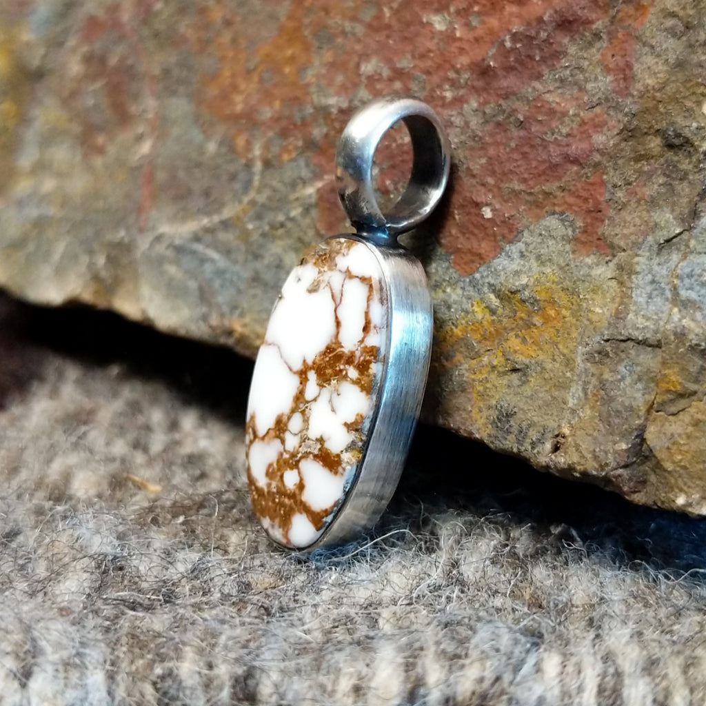 Wild horse stone in the shape of an oval set in the sterling silver bezel.