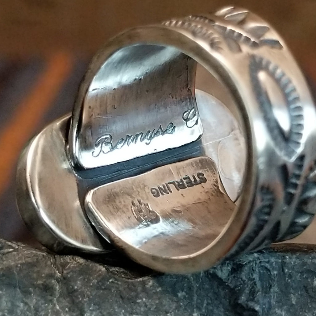 The interior of the ring showcases the artisan's signature and sterling silver stamp.