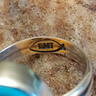Close-up of the artisans' stamped signature.