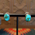 Sterling silver earrings with sonoran gold turquoise set in oval bezels.