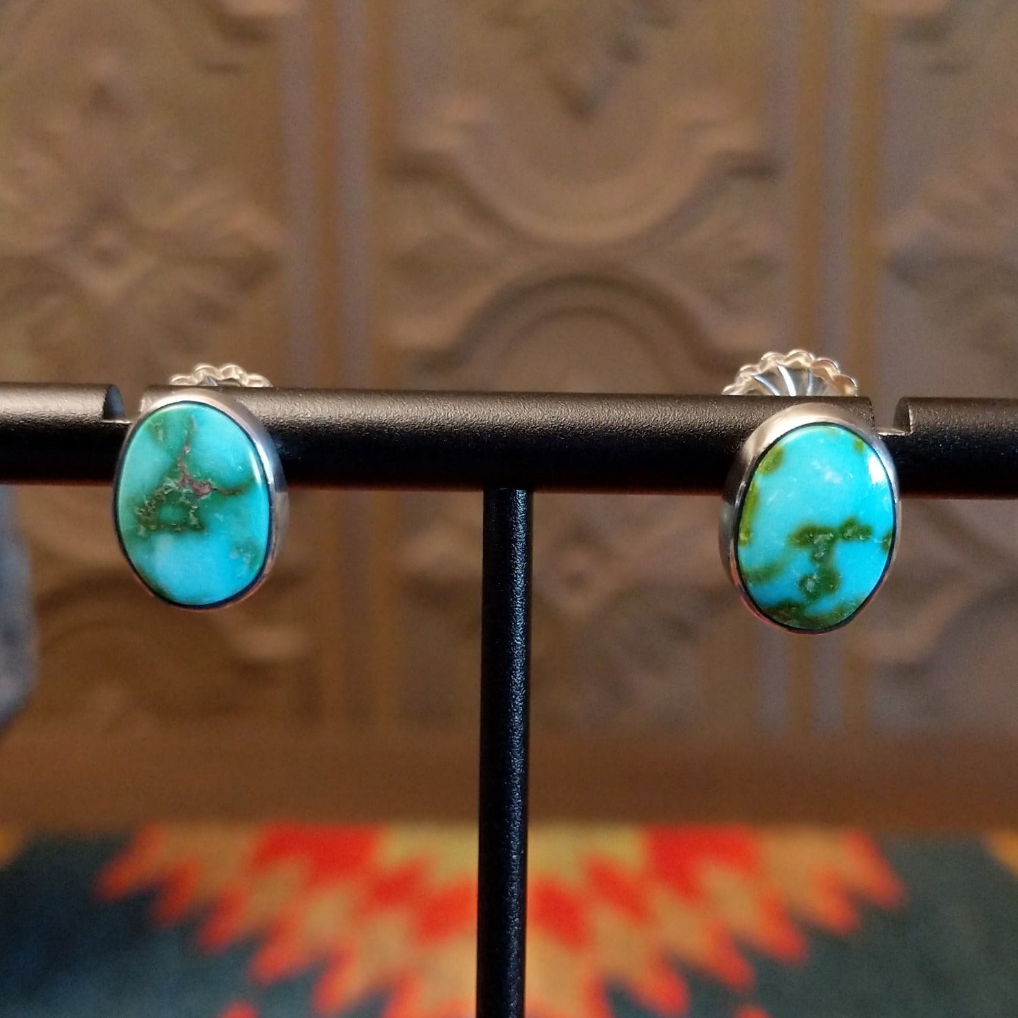 Sterling silver earrings with sonoran gold turquoise set in oval bezels.