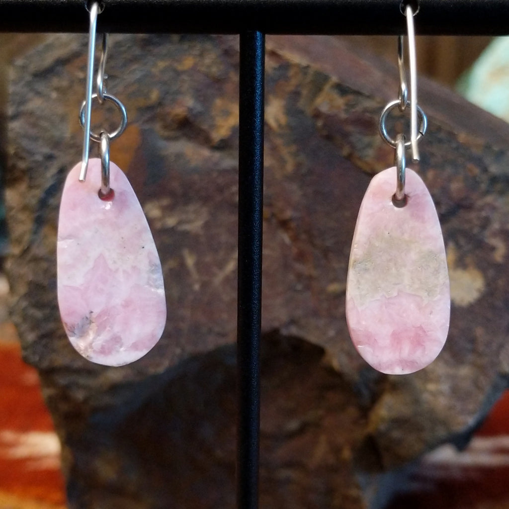 Ovoid rhodochrosite dangling from sterling silver hooks.