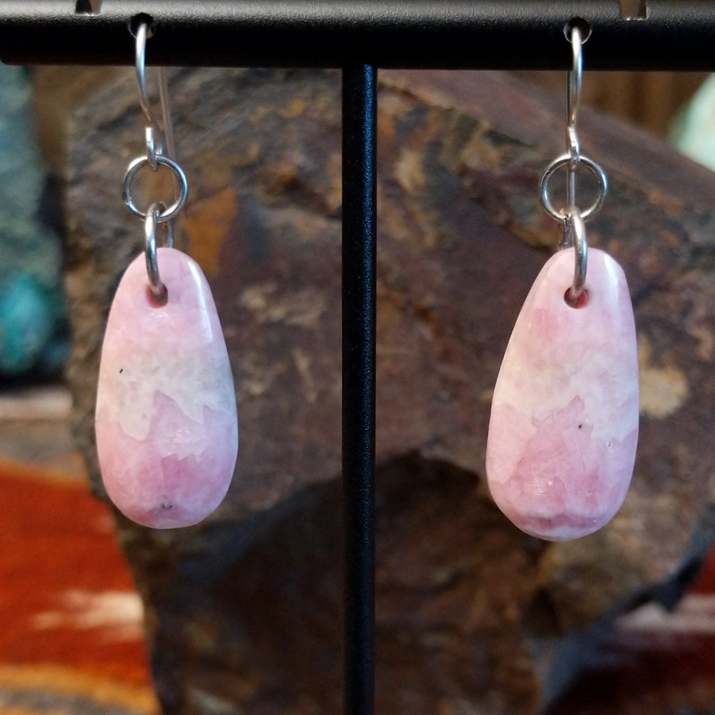 Ovoid rhodochrosite dangling from sterling silver hooks.
