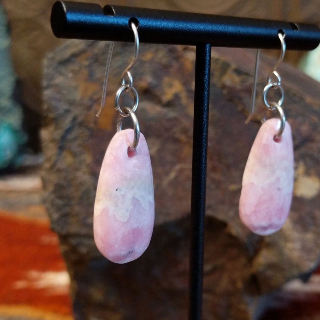 Ovoid rhodochrosite dangling from sterling silver hooks.