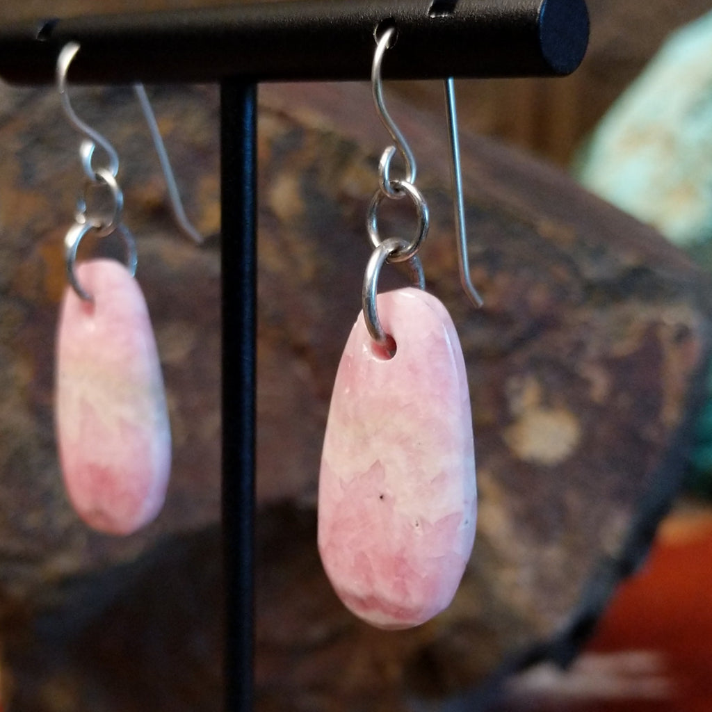 Ovoid rhodochrosite dangling from sterling silver hooks.