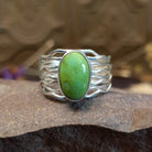 Sterling silver ring with Sonoran gold turquoise set in an oval bezel and strands of silver creating the band.