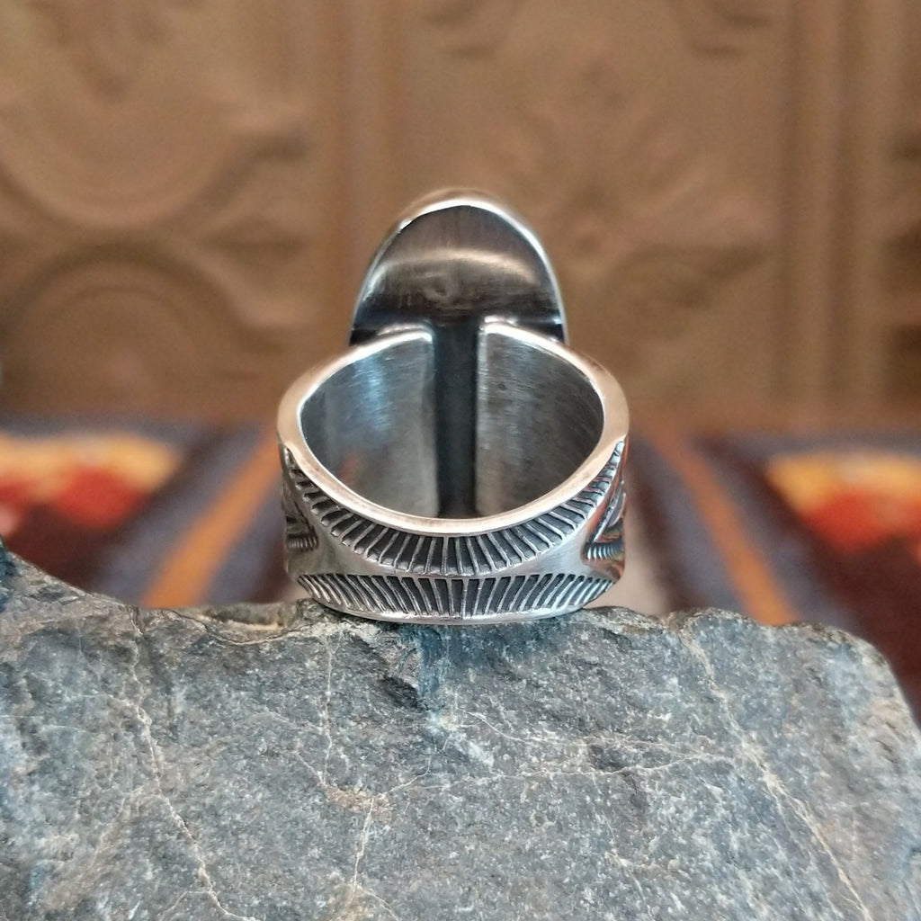 The intricately detailed sterling silver band of the ring.