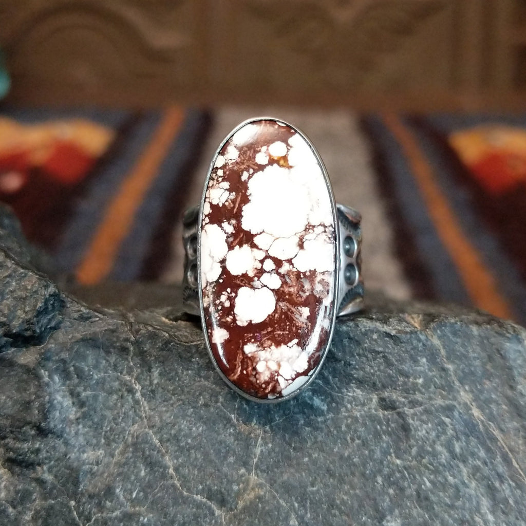 A wild horse stone within a sterling silver oval bezel, and an intricately detailed band.
