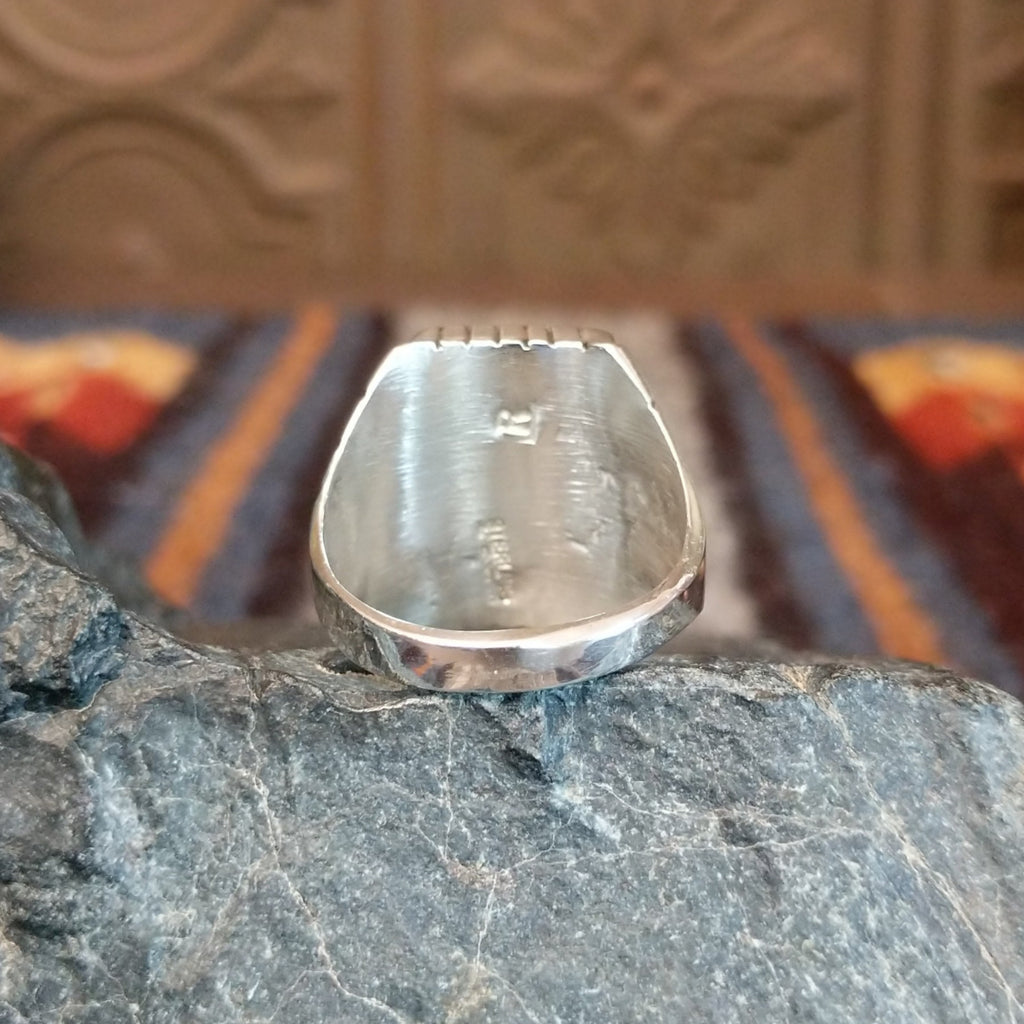 The back of the ring showcases the polished silver of the band.