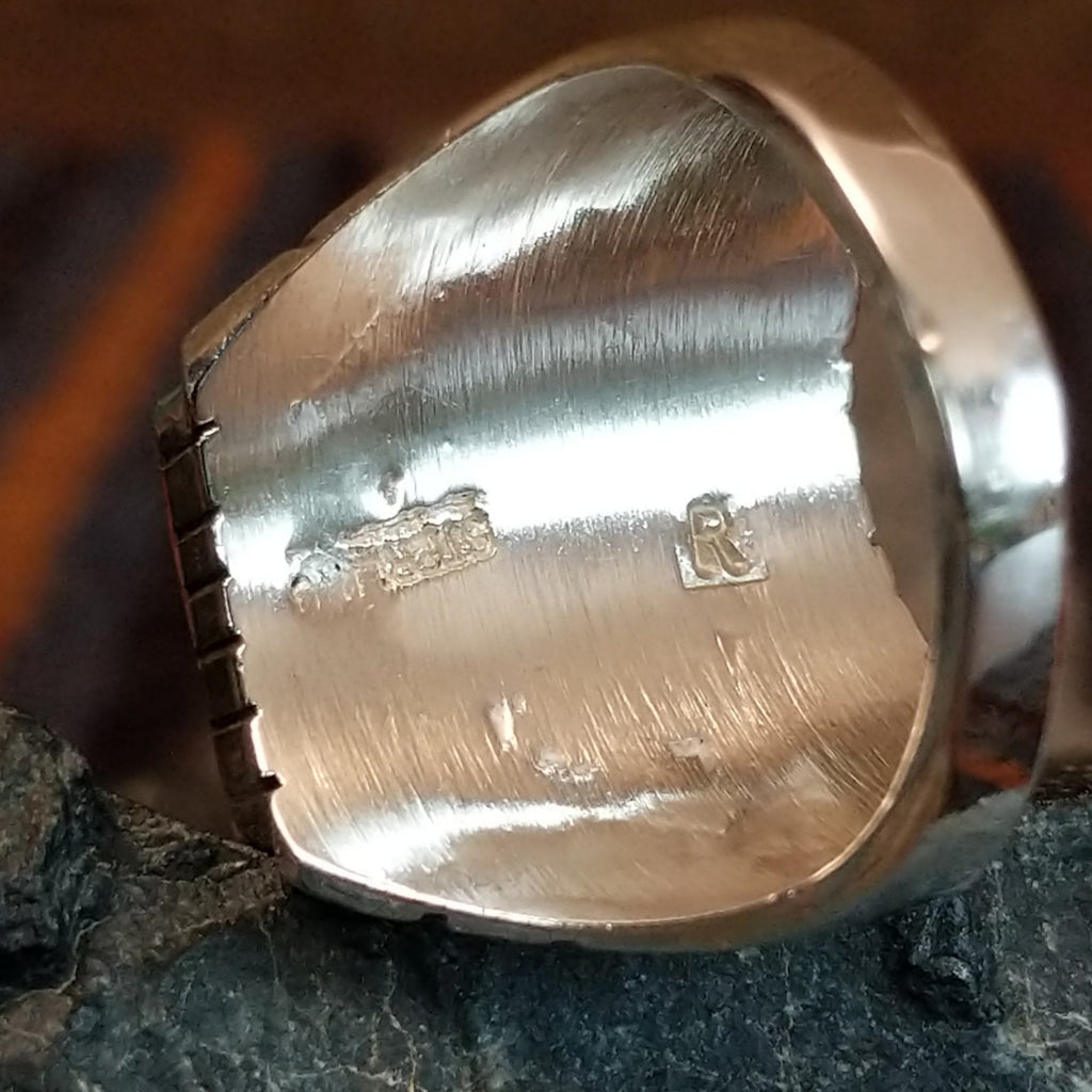 The maker’s stamp is found on the inside of the band.