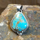 Genuine #8 Turquoise set in sterling silver with a rope accent detail.