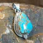 Genuine #8 Turquoise set in sterling silver with a rope accent detail.