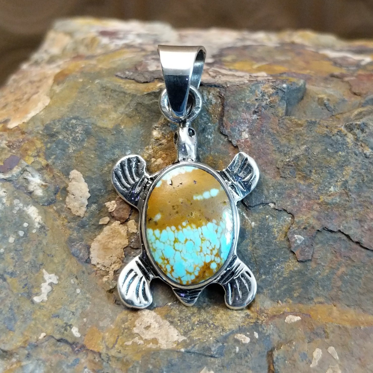 Handcrafted by Navajo artist K.S., this  pendant features genuine #8 Turquoise set in sterling silver. 