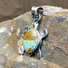 Handcrafted by Navajo artist K.S., this  pendant features genuine #8 Turquoise set in sterling silver. 