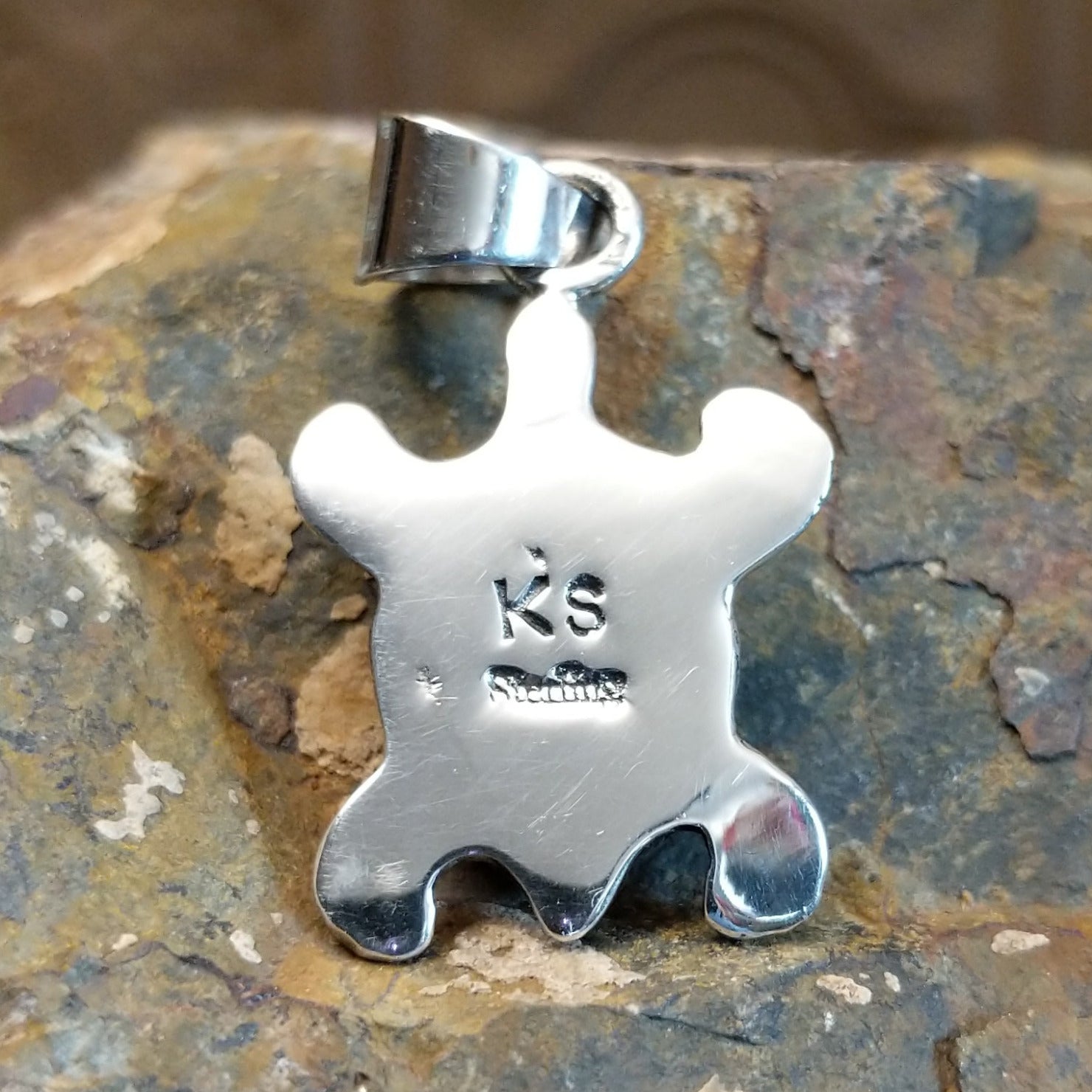 Artisan and Sterling stamp on back of pendant.
