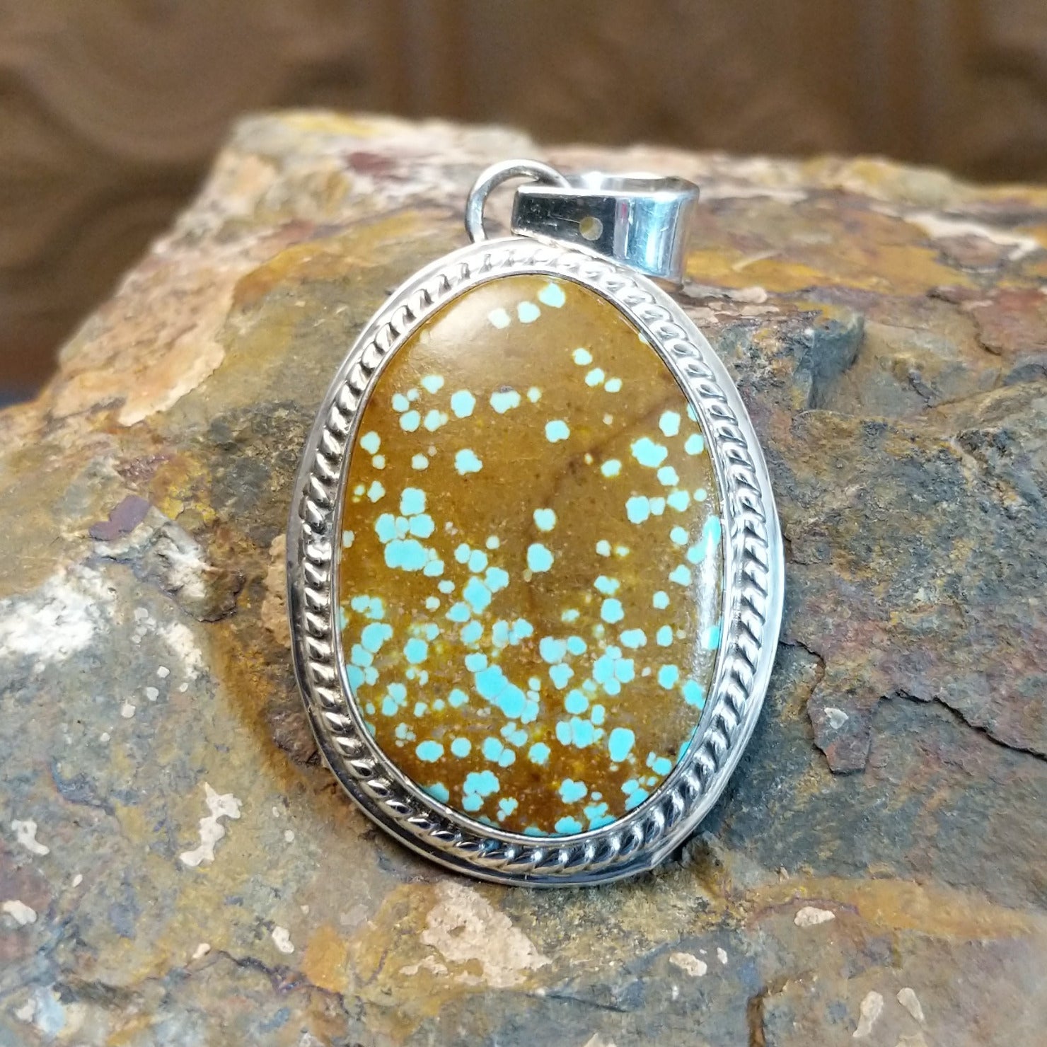 Handcrafted by Navajo artist L.P., this oval pendant features genuine #8 Turquoise set in sterling silver. 