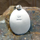 Artisan and Sterling Silver stamp on back of pendant.