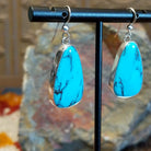 Kingman turquoise earrings by Navajo artists Everett & Mary Teller with deep burgundy matrix, side view.