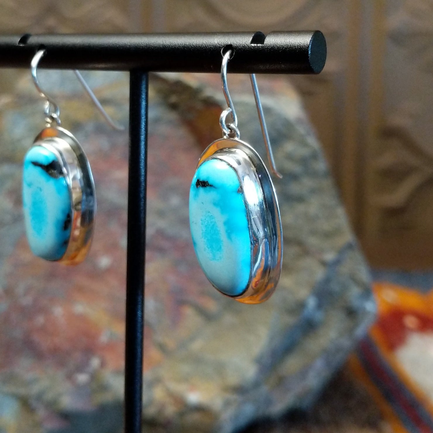 Framed turquoise earrings by Navajo artist Chris Billie, handcrafted in sterling silver, side view.