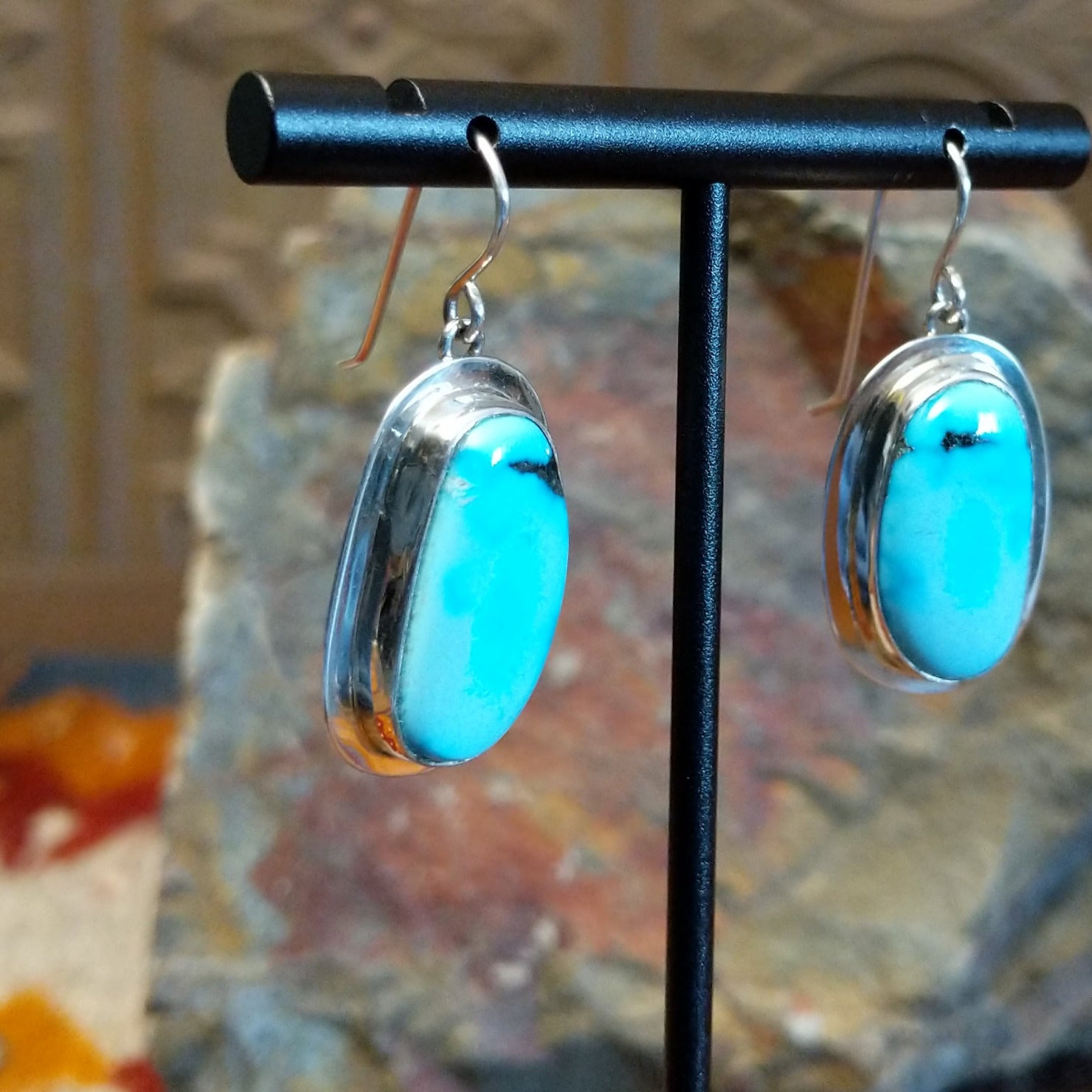 Framed turquoise earrings by Navajo artist Chris Billie, handcrafted in sterling silver, side view.