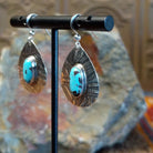  Kingman turquoise earrings by Navajo artists Everett & Mary Teller in planished sterling silver, side view.