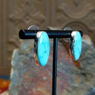 Turquoise Mountain turquoise ellipse earrings by Navajo artist Ann Curley, side view.