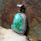  Sonoran Gold turquoise pendant by Navajo artist Burt Francisco, handcrafted in sterling silver with an etched setting. Side view.