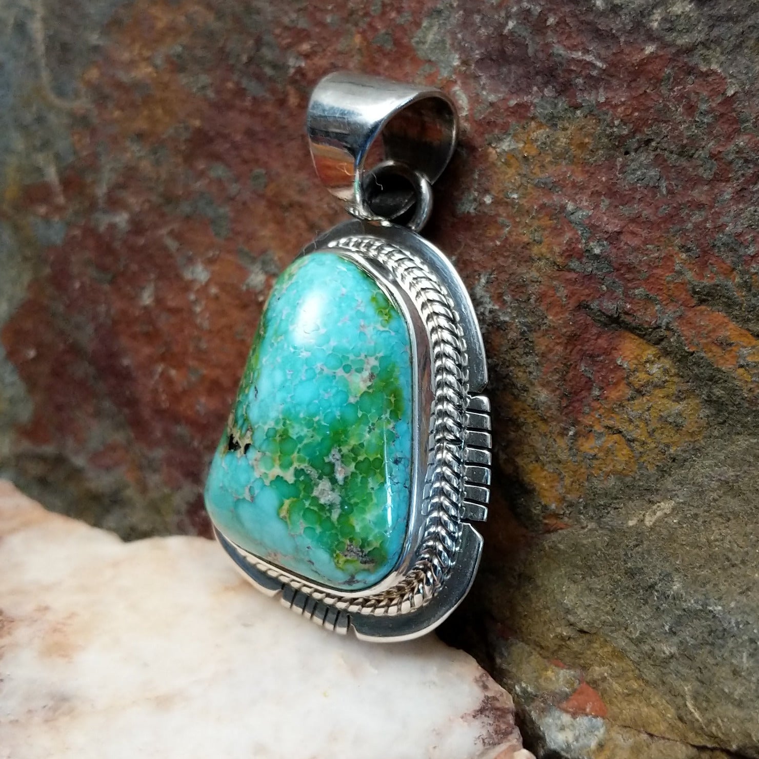  Sonoran Gold turquoise pendant by Navajo artist Burt Francisco, handcrafted in sterling silver with an etched setting. Side view.