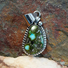 Sonoran Gold turquoise pendant by Navajo artist Verna Blackgoat, handcrafted in sterling silver with a scalloped setting.