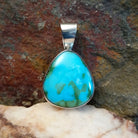 Bold and beautiful Sonoran Gold turquoise triangular pendant by Navajo artist Bernyse Chavez, set in Sterling Silver.