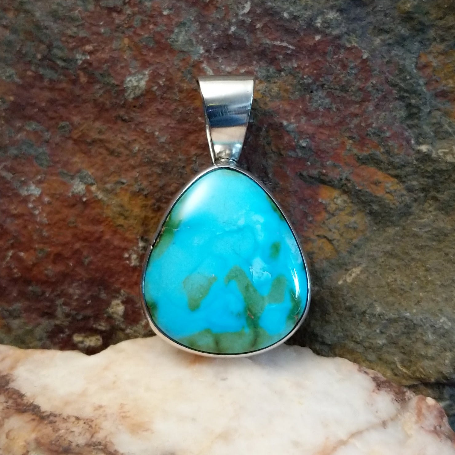 Bold and beautiful Sonoran Gold turquoise triangular pendant by Navajo artist Bernyse Chavez, set in Sterling Silver.