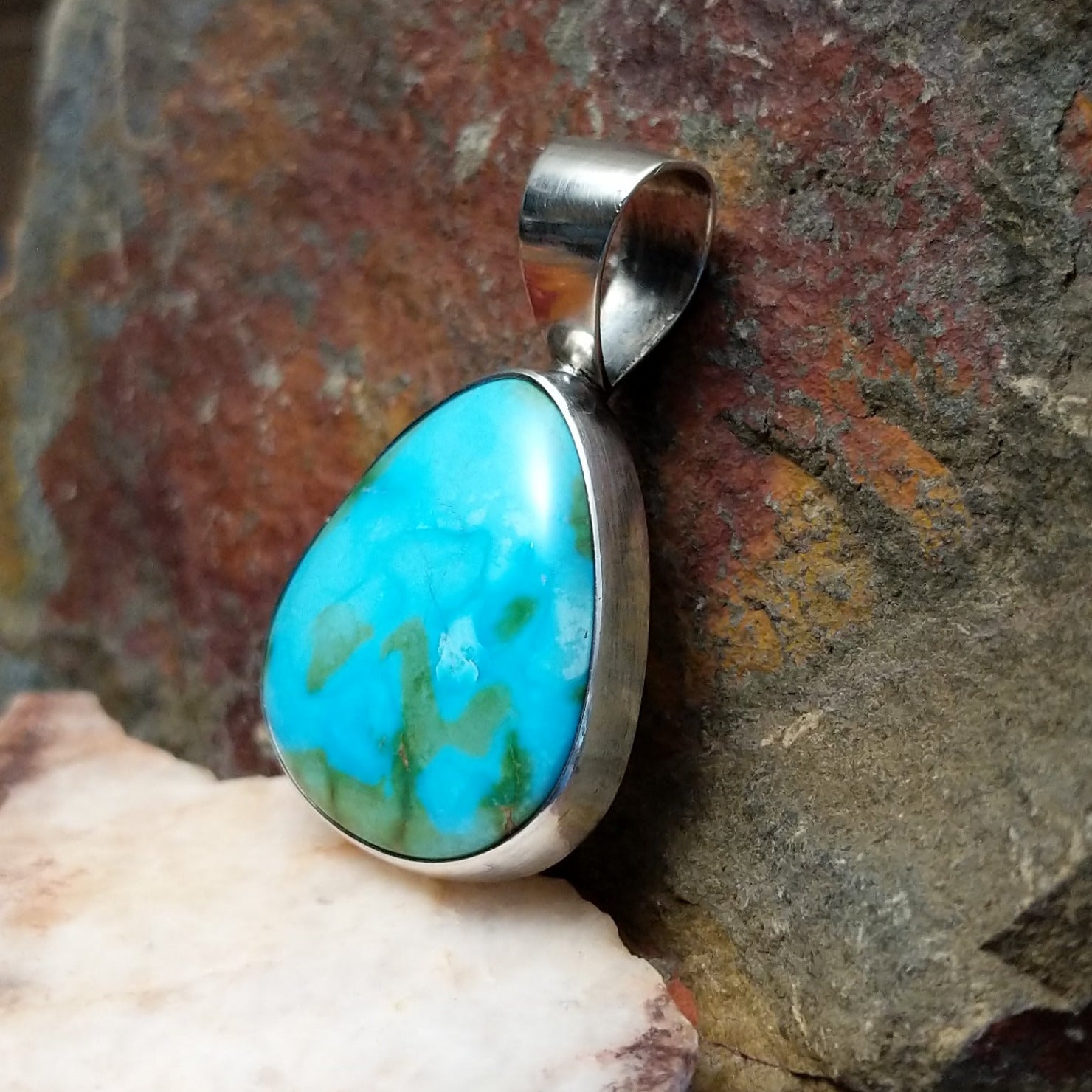 Bold and beautiful Sonoran Gold turquoise triangular pendant by Navajo artist Bernyse Chavez, set in Sterling Silver, side view.