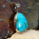 Bold and beautiful Sonoran Gold turquoise triangular pendant by Navajo artist Bernyse Chavez, set in Sterling Silver, side view.