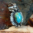 Sonoran Gold turquoise pendant by Navajo artist Rosita Calladitto, handcrafted in sterling silver, side view.