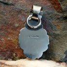 Artisan and Sterling Silver stamp on back of pendant.