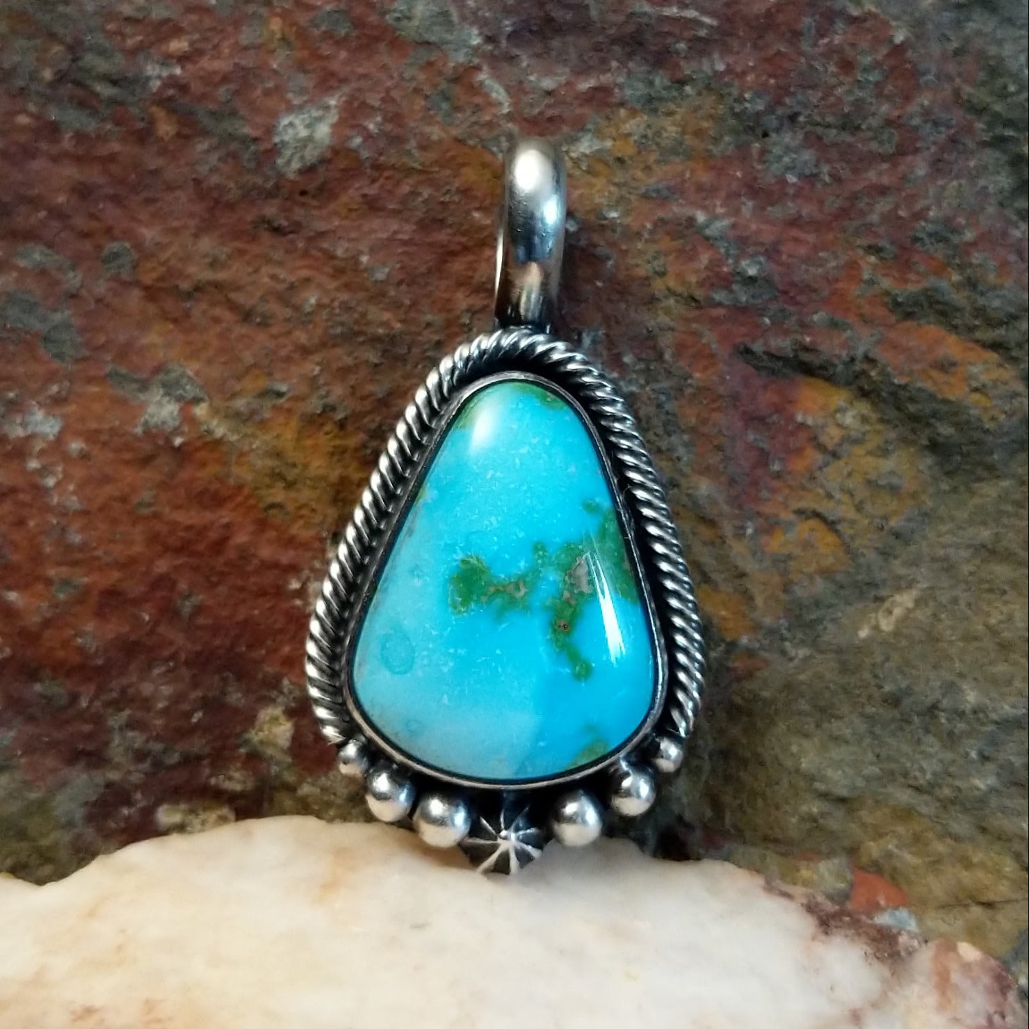  Sonoran Gold turquoise teardrop pendant by Navajo artist Bernyse Chavez, handcrafted in sterling silver, framed in rope setting.