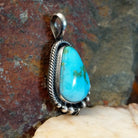  Sonoran Gold turquoise teardrop pendant by Navajo artist Bernyse Chavez, handcrafted in sterling silver, framed in rope setting- side view.