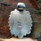 Artisan and Sterling Silver stamp on back of pendant.