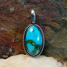  Sonoran Gold turquoise oval pendant by Navajo artist Lowell Draper, handcrafted in sterling silver with rope setting.