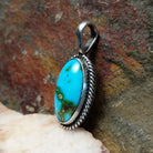  Sonoran Gold turquoise oval pendant by Navajo artist Lowell Draper, handcrafted in sterling silver with rope setting- side view.