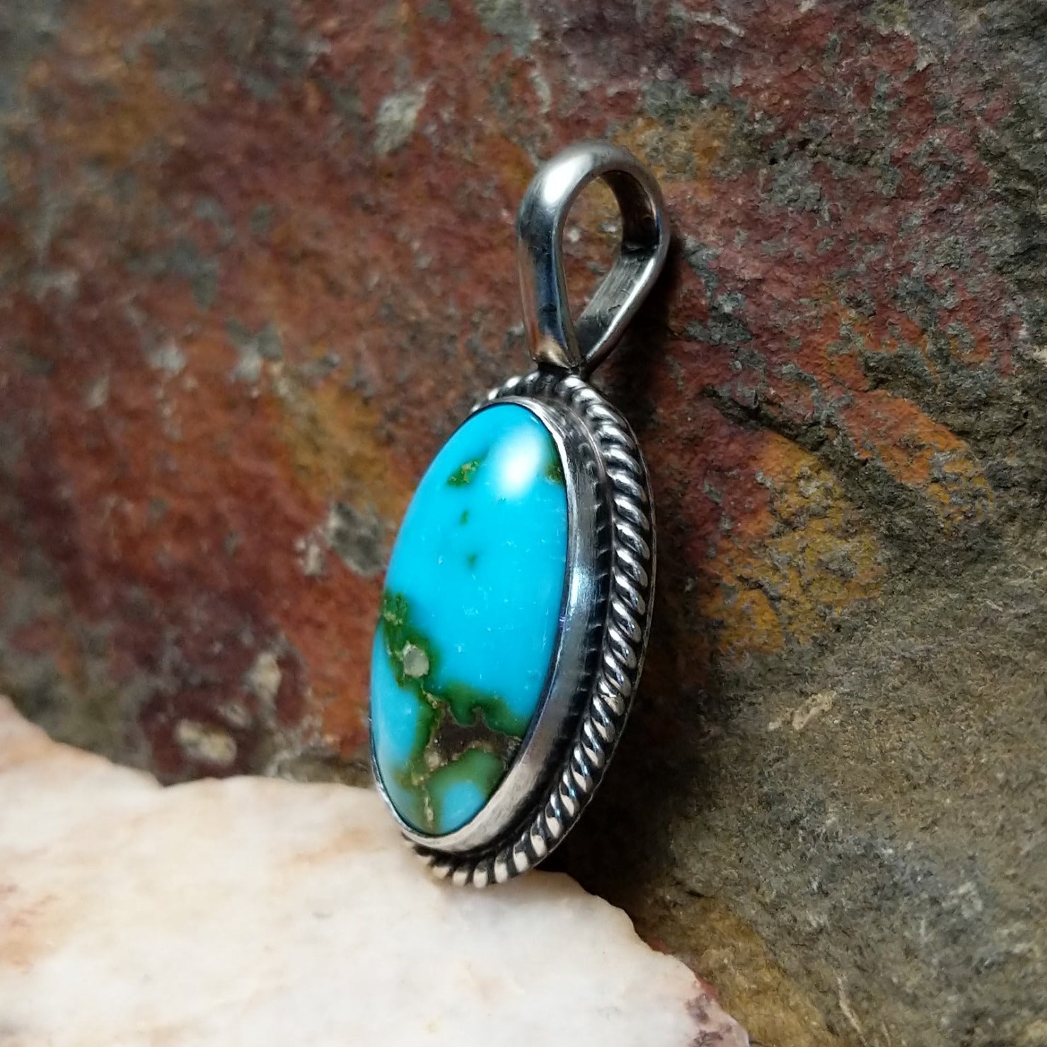  Sonoran Gold turquoise oval pendant by Navajo artist Lowell Draper, handcrafted in sterling silver with rope setting- side view.