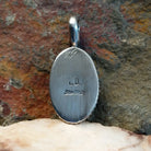 Artisan and Sterling Silver stamp on back of pendant.