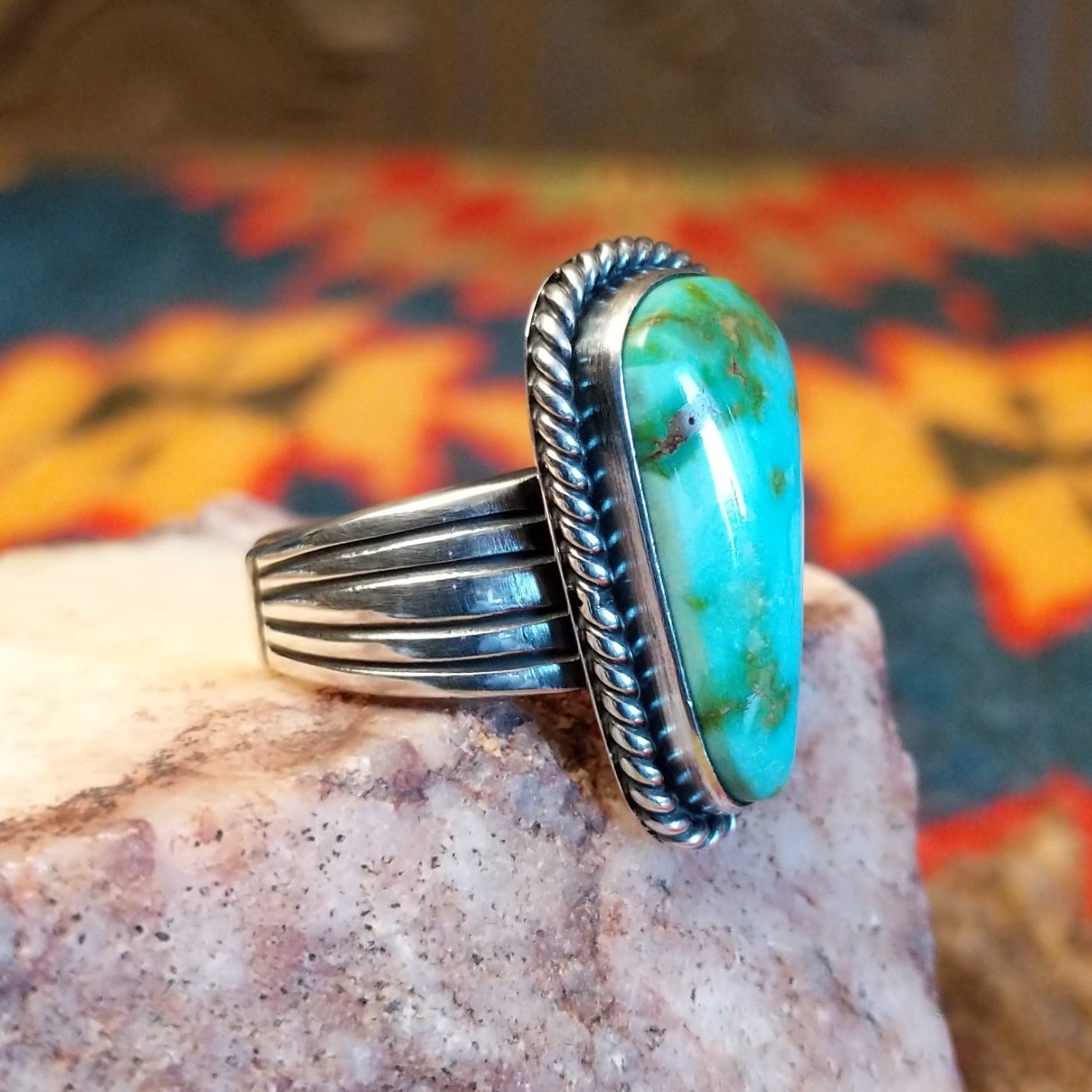 Sonoran Gold Turquoise ovate shaped stone set in sterling silver. Created by Murphy Platero, size 6.5 side view.