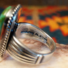 Artisan stamp on band of ring.