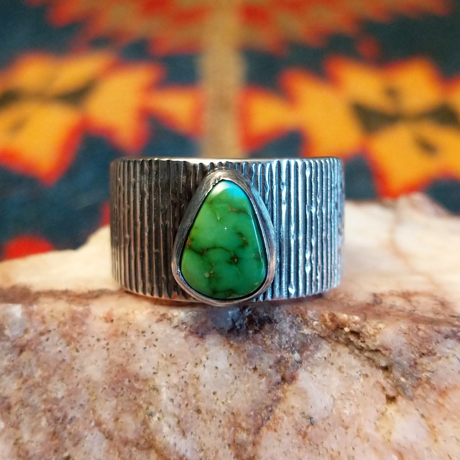 Sonoran Gold Turquoise stone in a teardrop shape. Made by Elgin Tom, this ring is size 9 and set in Sterling Silver; front view.