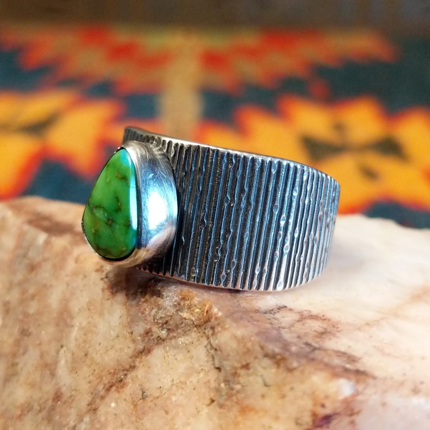 Sonoran Gold Turquoise stone in a teardrop shape. Made by Elgin Tom, this ring is size 9 and set in Sterling Silver; side view.