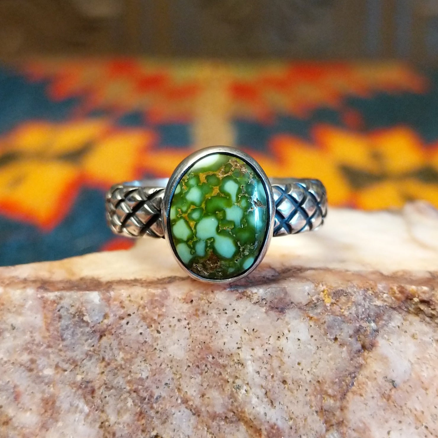 Sonoran Gold Turquoise stone in a classic circular cut, set in sterling silver. Made by Navajo Native Raymond Coriz, this ring is size 9.5, front view.