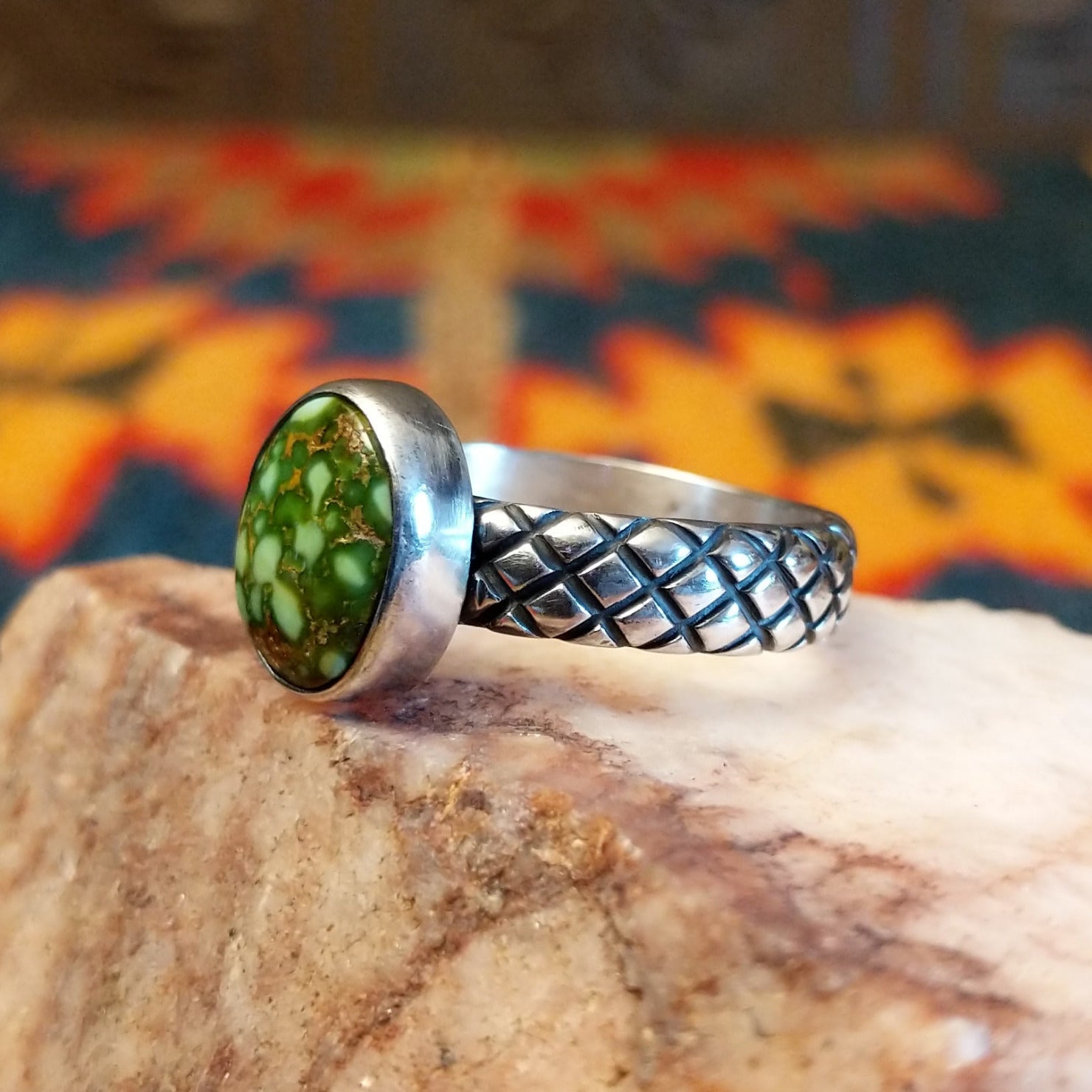 Sonoran Gold Turquoise stone in a classic circular cut, set in sterling silver. Made by Navajo Native Raymond Coriz, this ring is size 9.5, side view.