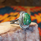 Sonoran Gold Turquoise stone set in etched sterling silver, with a classic rope design. Made by Jake Sampson, this ring is size 8, side view.