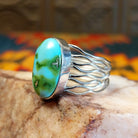 Sonoran Gold Turquoise oval stone in a strand-style setting, set in sterling silver. Made by Murphy Platero, this ring is size 8, side view.